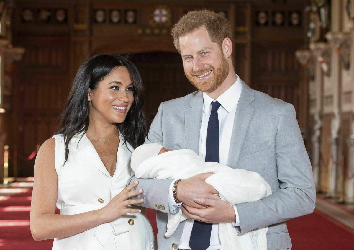Britain’s Prince Harry and Meghan, Duchess of Sussex, pose during a photocall with their newborn son, in St George’s Hall at Windsor Castle, England on Wednesday May 8, 2019.