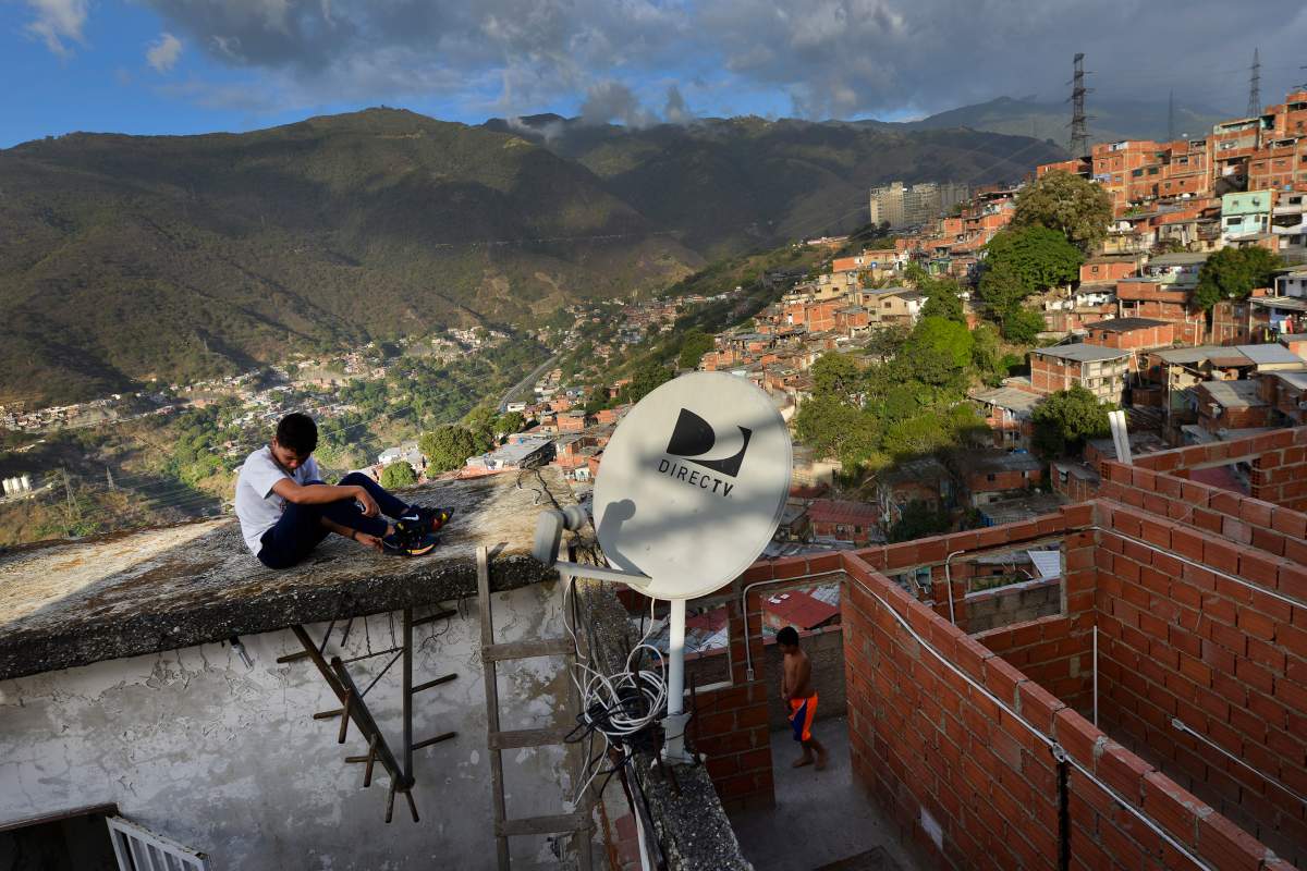 A DirectTV dish stands on home in the Catia neighborhood of Caracas, Venezuela, Thursday, Jan. 9, 2020. Venezuelan President Maduros opponents want AT&Ts DirecTV unit to restore a number of channels it was required to take down from its lineup. But forcing AT&T to do the political bidding of Maduros foes could lead to retaliation and likely exit from a market where it has a whopping 44% market share.