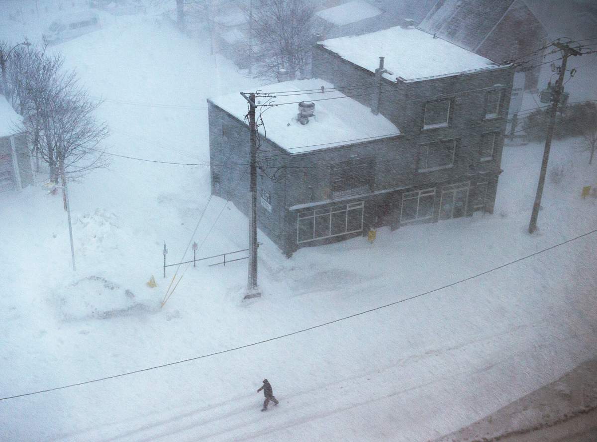 A man walks down the middle of New Gower Street in St. John’s as a major winter storm hits the Avalon Peninsula on Friday, Jan. 17, 2020. Schools, government offices and most businesses are closed due to the blizzard conditions. THE CANADIAN PRESS/Andrew Vaughan