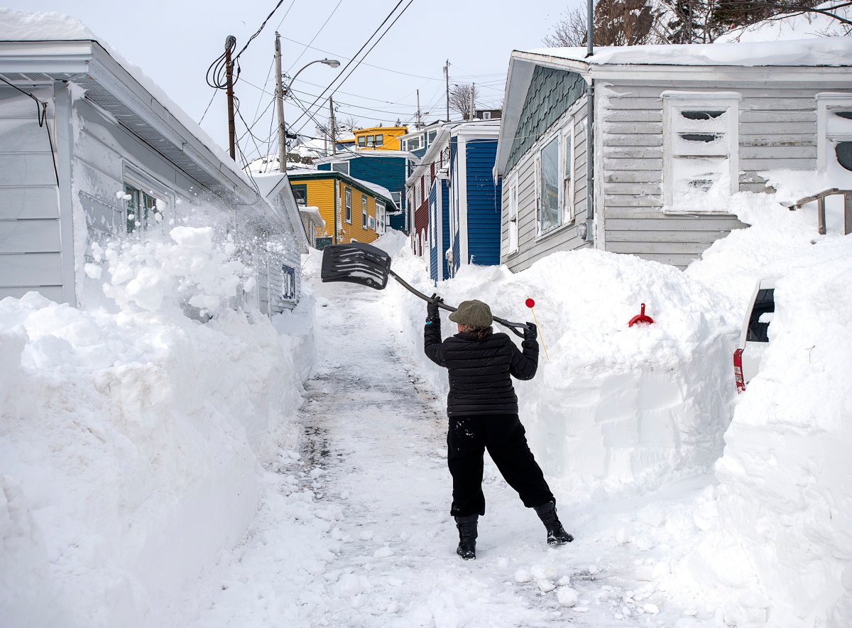 A resident clears snow in St. John’s on Sunday, Jan. 19, 2020.