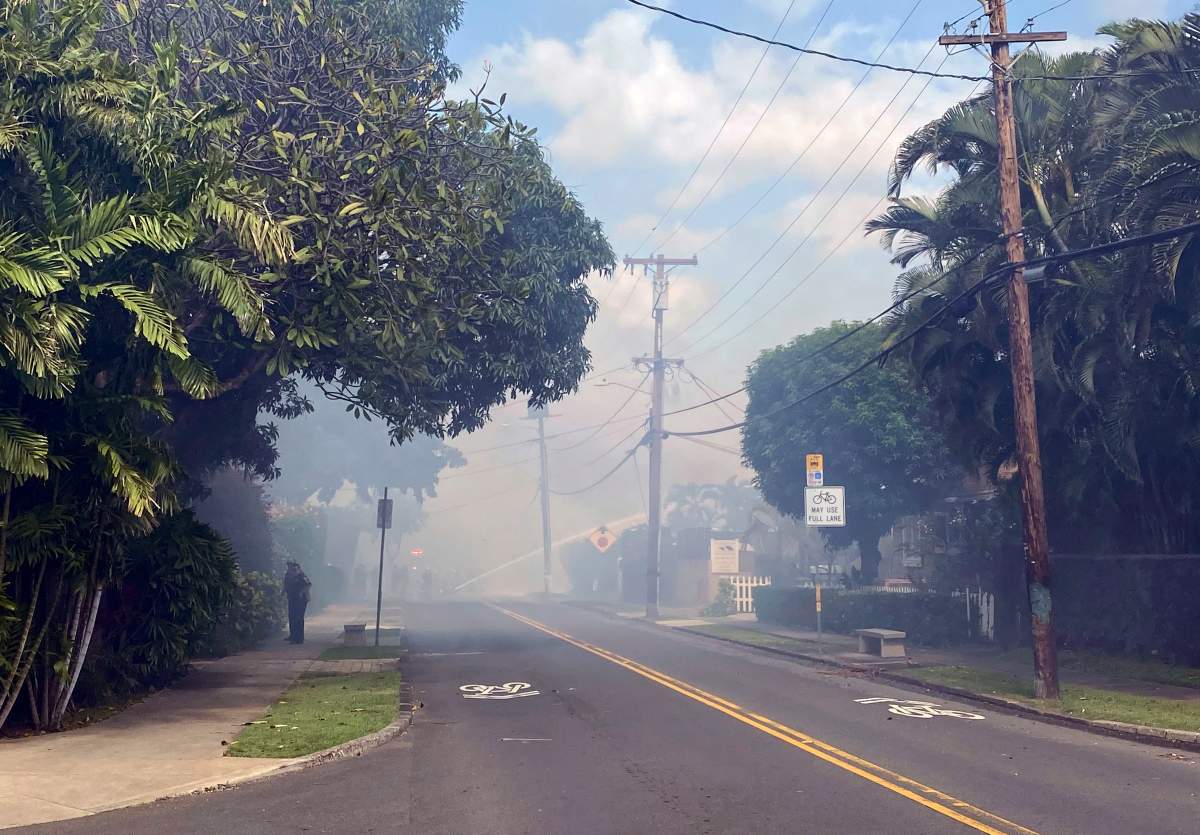 Smoke billows through the streets after a shooting in Honolulu, Jan. 19, 2020.