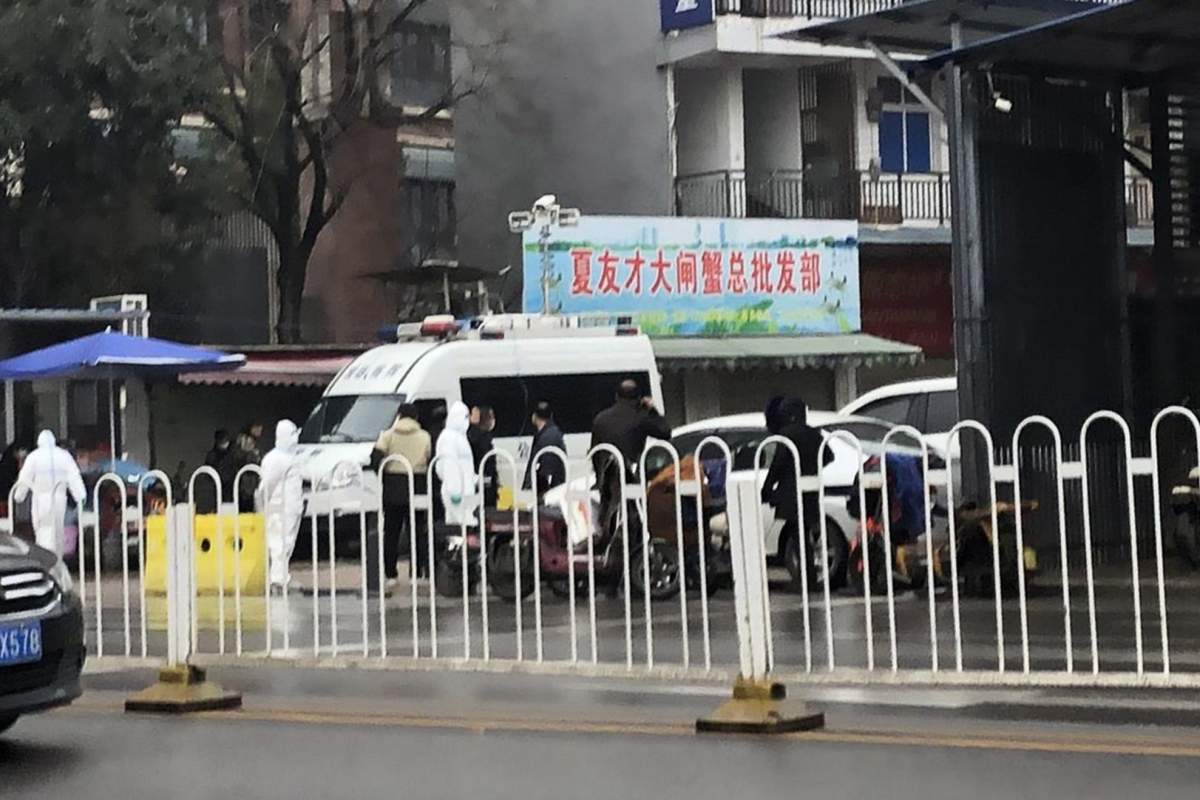 Chinese quarantine workers wearing protective suits and masks are posted at an entrance to the Huanan Seafood Wholesale Market in Wuhan, central China, 21 January 2020.