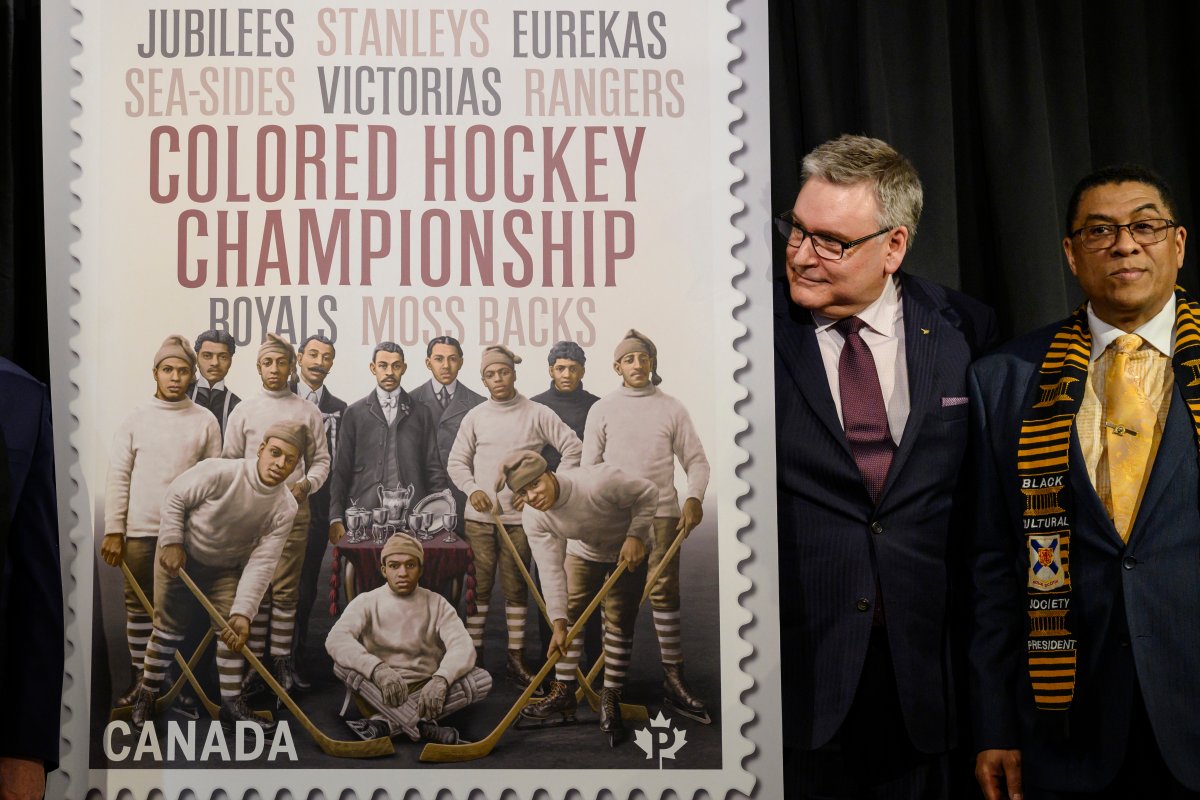 Doug Ettinger, left, President and CEO of Canada Post, and Craig Smith, President of The Black Cultural Society, unveil Canada Post's new stamp honouring the Colored Hockey Championship and the all-Black hockey teams in the Maritimes between 1895 and the early 1930s during an event at the Black Cultural Centre for Nova Scotia in Halifax on Thursday, January 23, 2020. 