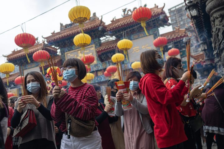 Worshippers wear face masks while praying at Wong Tai Sin Temple on the first day of the Lunar New Year of the Rat in Hong Kong, China, 25 January 2020.