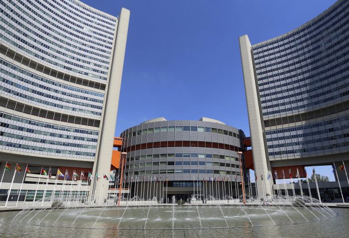 In this June 18, 2014, file photo flags fly outside the United Nations building in Vienna, Austria. 