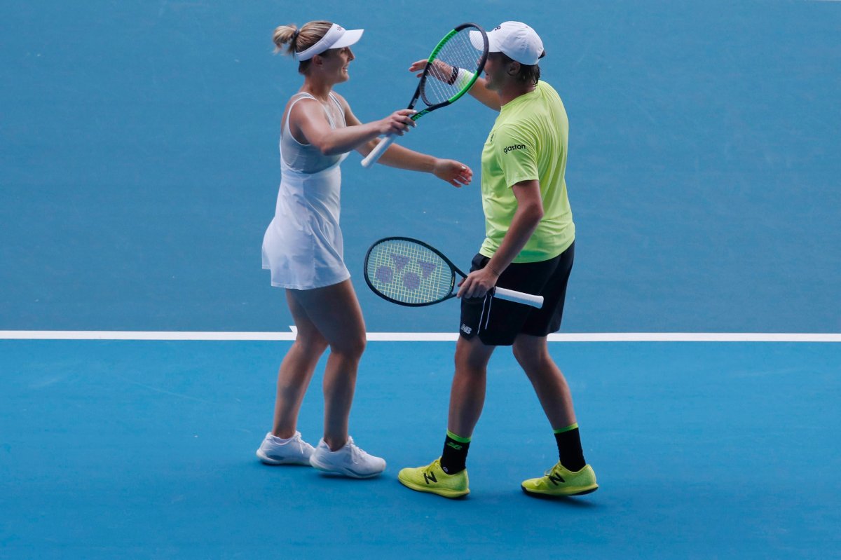 Henri Kontinen of Finland and Gabriela Dabrowski of Canada react after winning their mixed doubles quarterfinal match against Latisha Chan of Taipei and Ivan Dodig of Croatia at the Australian Open Grand Slam tennis tournament in Melbourne, Australia, on Jan. 30, 2020.