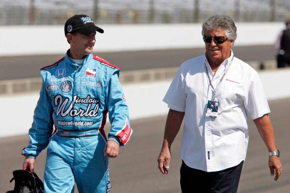 In this May 10, 2009, file photo, John Andretti, left, walks out of the pit area his his uncle, Mario Andretti, after a practice session on the second day of qualifications for the Indianapolis 500 auto race at the Indianapolis Motor Speedway in Indianapolis. (AP Photo/Darron Cummings, File)