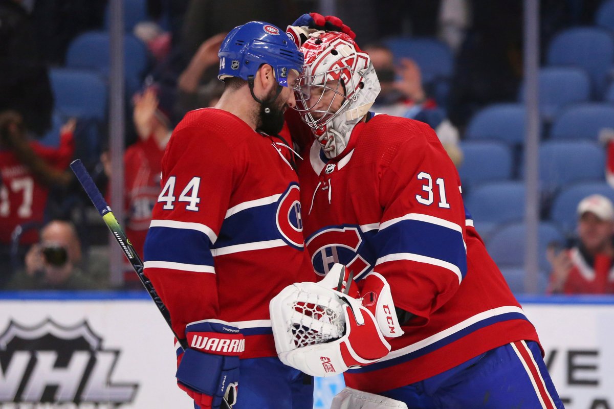 Montreal Canadiens forward Nate Thompson (44) and goalie Carey Price (31) celebrate the team's 3-1 victory over the Buffalo Sabres in an NHL hockey game Thursday, Jan. 30, 2020, in Buffalo, N.Y. 