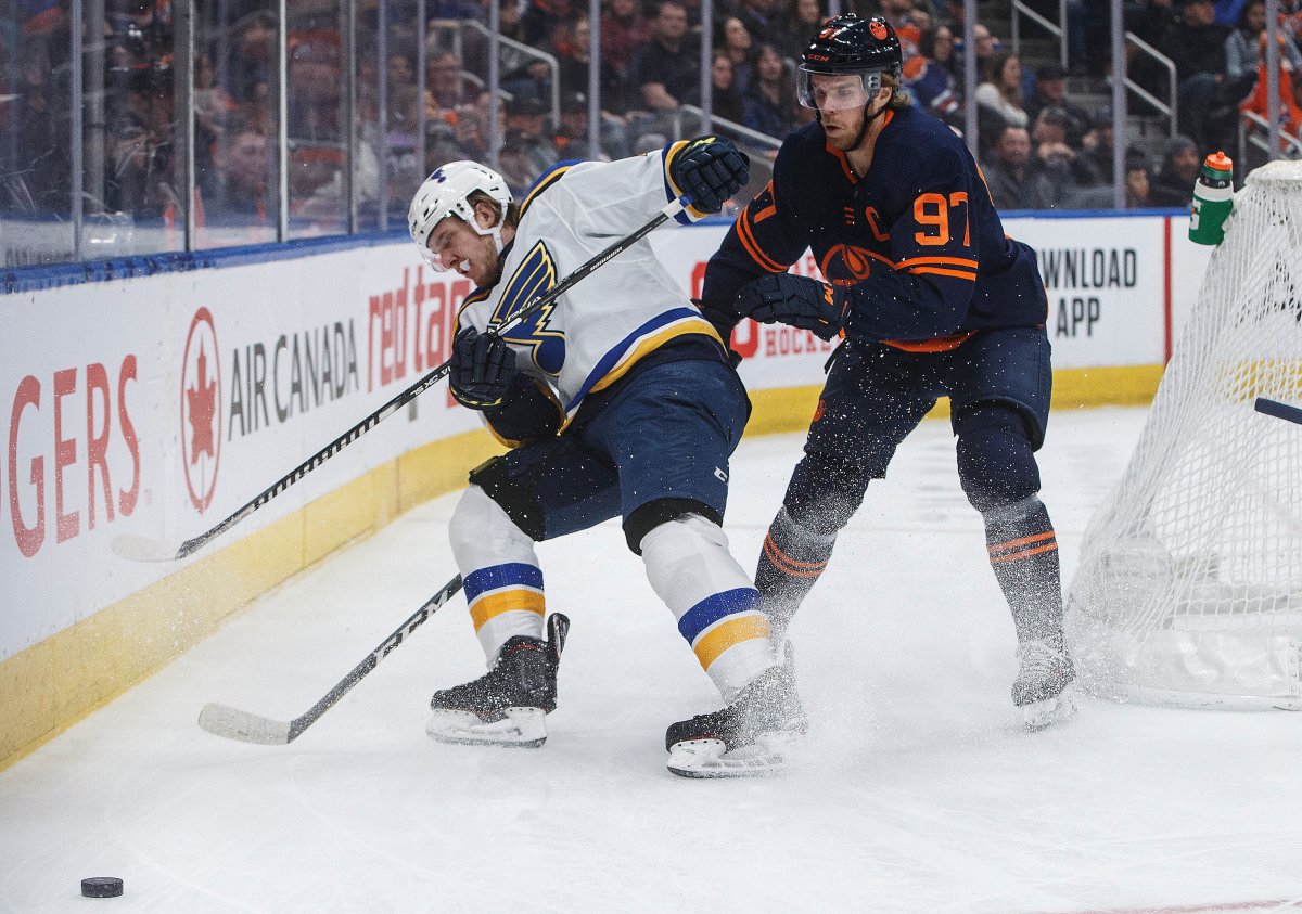St. Louis Blues' Robert Thomas (18) and Edmonton Oilers' Connor McDavid (97) battle for the puck during first period NHL action in Edmonton, Alta., on Friday January 31, 2020. THE CANADIAN PRESS/Jason Franson.