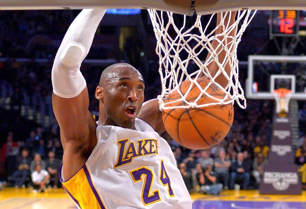 In this Jan. 4, 2015, file photo Los Angeles Lakers guard Kobe Bryant dunks during the first half of an NBA basketball game against the Indiana Pacers in Los Angeles, Calif.