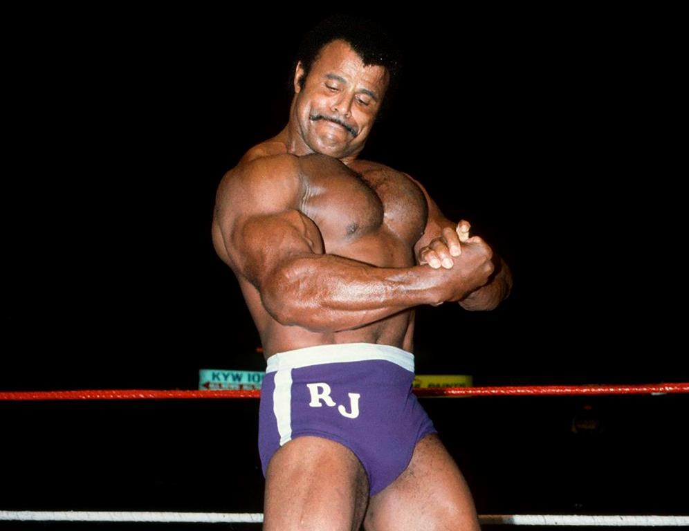 In this undated photo provided by WWE, Inc., Rocky (Soul Man) Johnson poses in the ring. Johnson, a WWE Hall of Fame wrestler who became better known as the father of actor Dwayne (The Rock) Johnson, died Wednesday, Jan. 15, 2020. He was 75. (WWE, Inc. via AP)