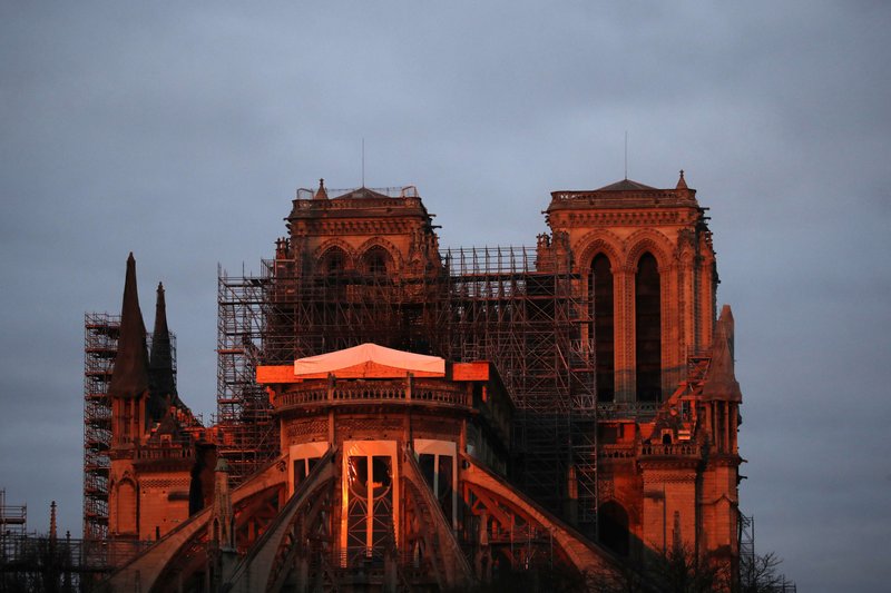Notre Dame cathedral is pictured when the sun rises, in Paris, Sunday, Jan. 5, 2020. Gen. Jean-Louis Georgelin who is overseeing the reconstruction of the fire-devastated Notre Dame Cathedral told French broadcaster CNews on Sunday that "the cathedral is still in a state of peril" after last year's fire, which destroyed its roof and collapsed its spire as the cathedral was undergoing renovations. 