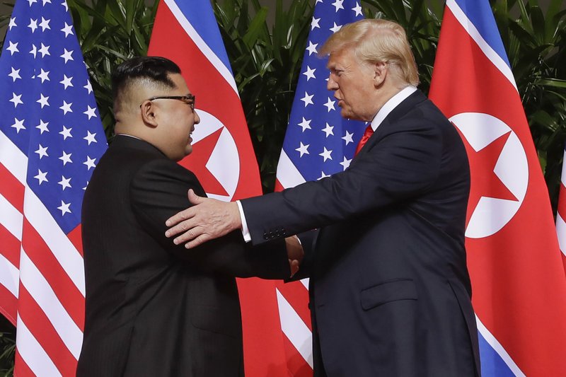 FILE - In this June 12, 2018, file photo, U.S. President Donald Trump, right, shakes hands with North Korea leader Kim Jong Un at the Capella resort on Sentosa Island in Singapore. South Korea said Friday, Jan. 10, 2020, it conveyed a message by President Donald Trump to North Korean leader Kim Jong Un wishing him a happy birthday, which is believed to be Jan. 8. 