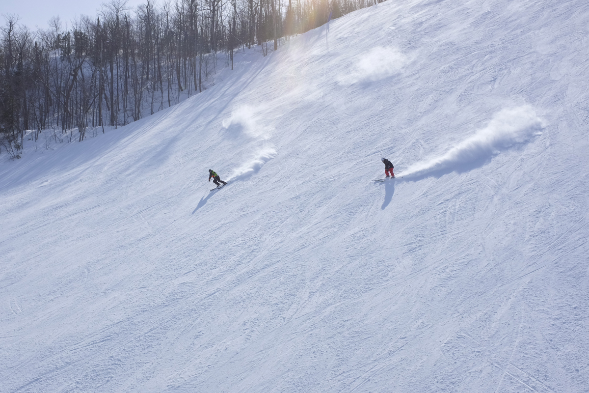 Skiers arc turns down a Blue Mountain ski run near Collingwood, Ontario.