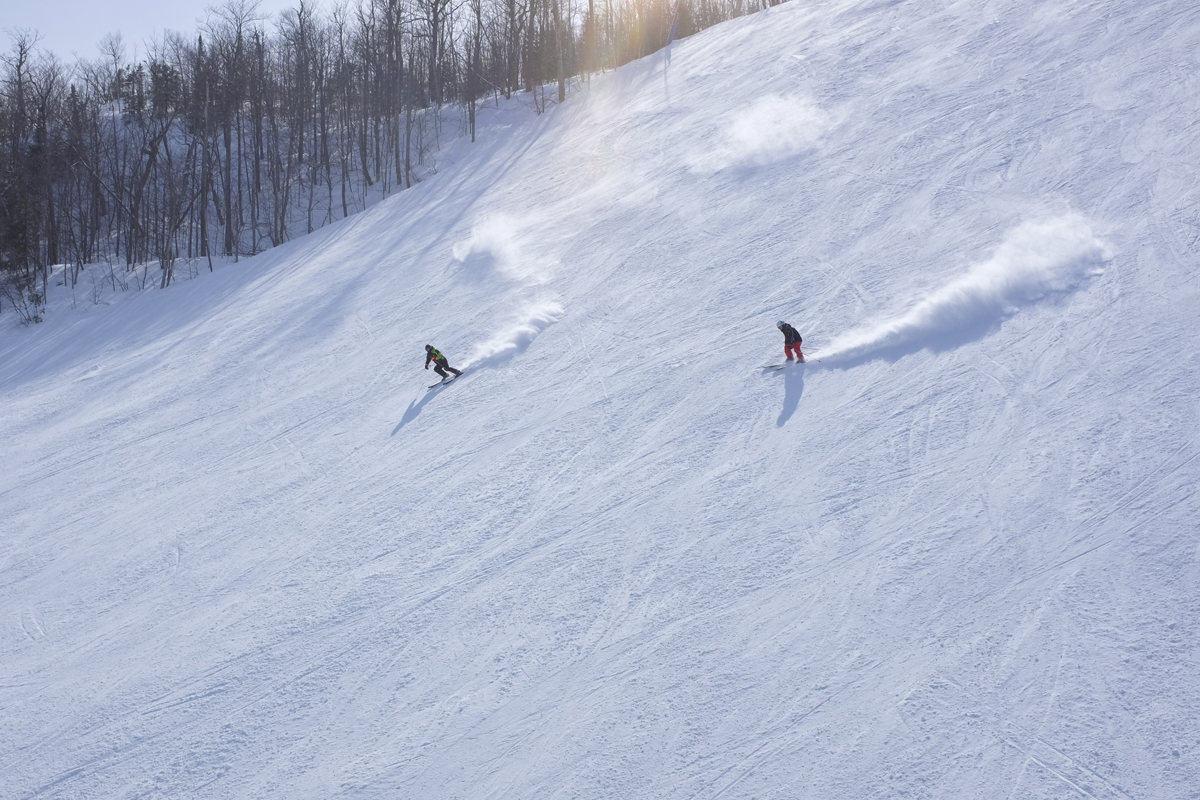 Skiers arc turns down a Blue Mountain ski run near Collingwood, Ontario.