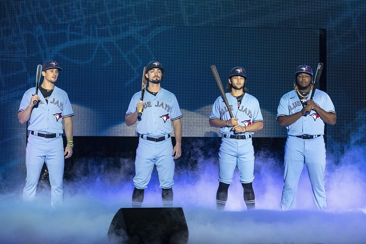 Toronto Blue Jays’ Cavan Biggio, left to right, Randal Grichuk, Bo Bichette and Vladimir Guerrero Jr. unveil the team’s new blue jersey during their Winter Fest celebration in Toronto on Saturday January 18, 2020.