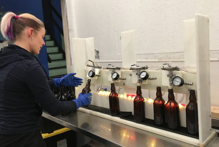 Staff at Uncommon Cider Co. get bottles ready for distribution.