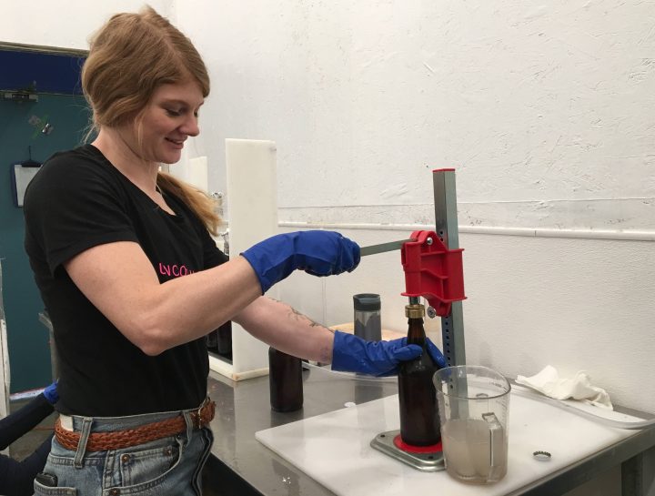 Staff at Uncommon Cider Co. get bottles ready for distribution.