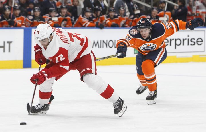 Detroit Red Wings' Andreas Athanasiou (72) is chased by Edmonton Oilers' Brandon Manning (26) during third period NHL action in Edmonton on Tuesday, Jan. 22, 2019. 