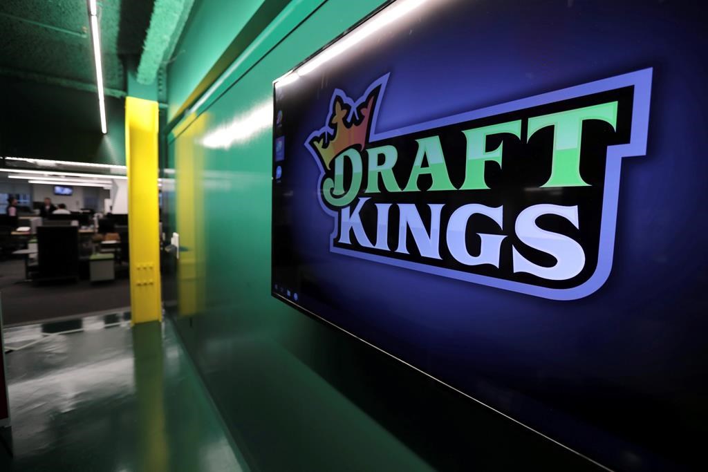 FILE - In this May 2, 2019, file photo, the DraftKings logo is displayed at the sports betting company headquarters in Boston. 