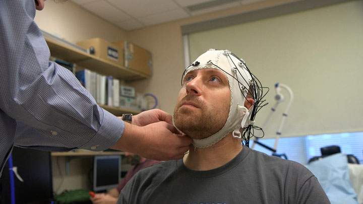 Zach Ault is fitted with an EEG cap which uses electrodes to track the electrical activity of his brain, at the National Institutes of Health’s hospital in Bethesda, Md.