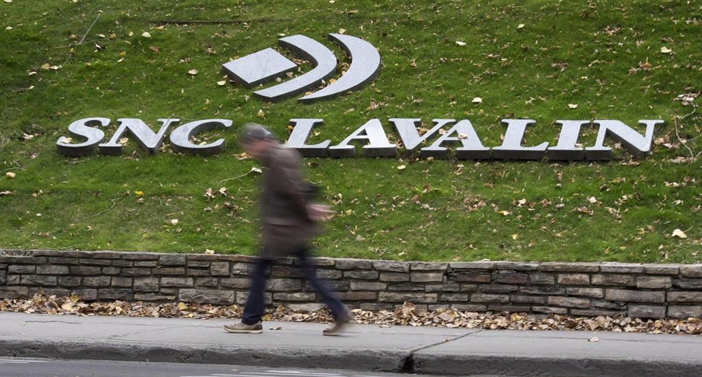 A man walks past the headquarters of SNC-Lavalin in Montreal on November 6, 2014.
