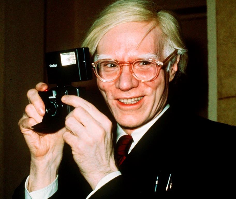 In this 1976 file photo, pop artist Andy Warhol smiles in New York.