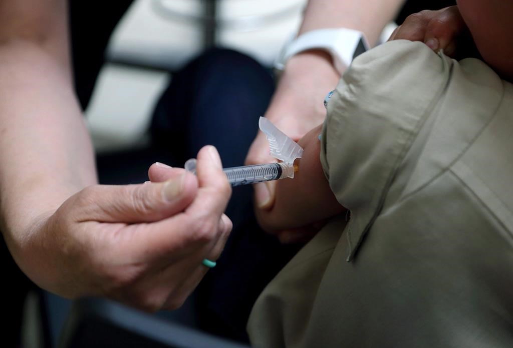 A registered nurse administers a vaccination to a young boy in Mount Vernon, Ohio on May 17, 2019.