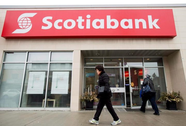 People are seen entering and leaving a Scotiabank branch in Toronto on Thursday, April 9, 2015. 