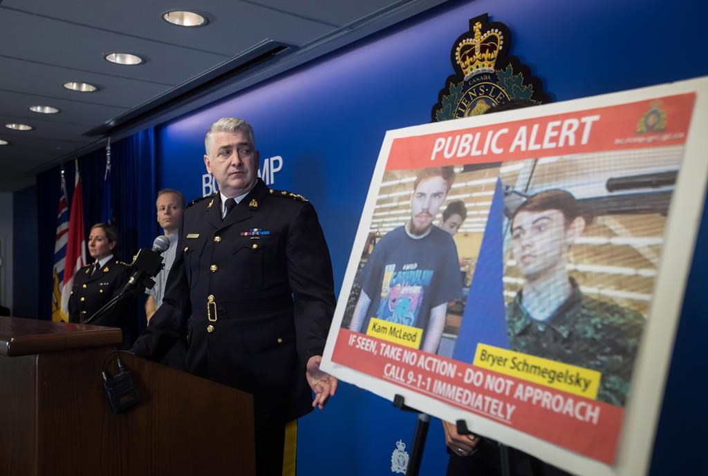 Security camera images recorded in Saskatchewan of Kam McLeod, 19, and Bryer Schmegelsky, 18, are displayed as RCMP Assistant Commissioner Kevin Hackett steps away from the podium after speaking during a news conference in Surrey, B.C., on Tuesday July 23, 2019.