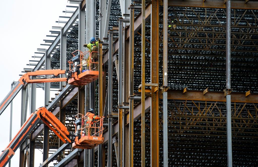 Steel workers build a structure in Ottawa on March 5, 2018.