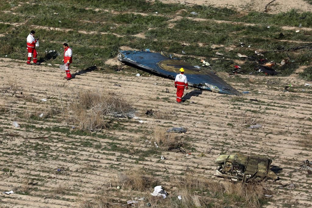 Rescue workers search the scene where a Ukrainian plane crashed in Shahedshahr, southwest of the capital Tehran, Iran, on Jan. 8.