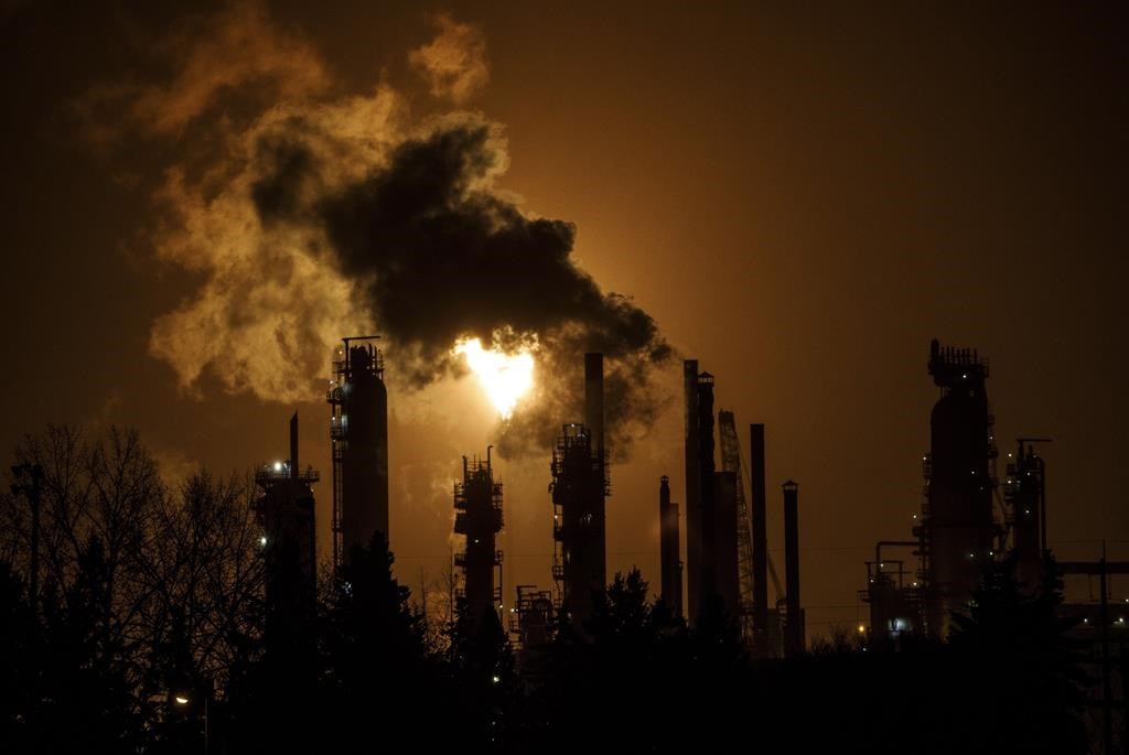 A flare stack lights the sky from the Imperial Oil refinery in Edmonton on December 28, 2018. A new climate change think tank funded by the federal government says Canadians should expect to face the harsh realities of a changing climate even under the most aggressive global efforts to curb fossil fuel use and cut greenhouse gas emissions. THE CANADIAN PRESS/Jason Franson.