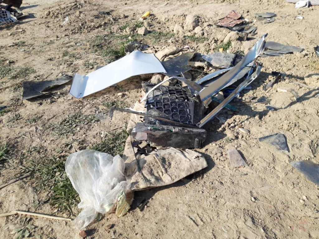 Unidentifiable pieces of the aircraft, as well as what appears to be a keyboard, laid in piles at the crash site.