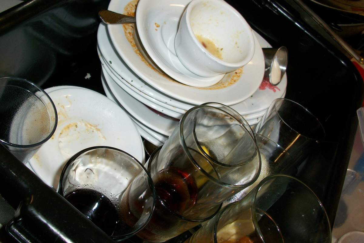 A pile of dirty dishes in a sink.