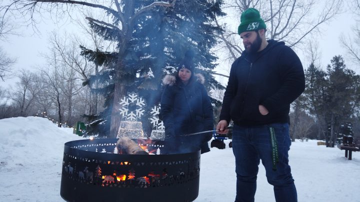 Skaters warm up by a bonfire near the skating loop at Aspen Campground in Echo Valley Provincial Park, about a 40-minute drive from Regina.