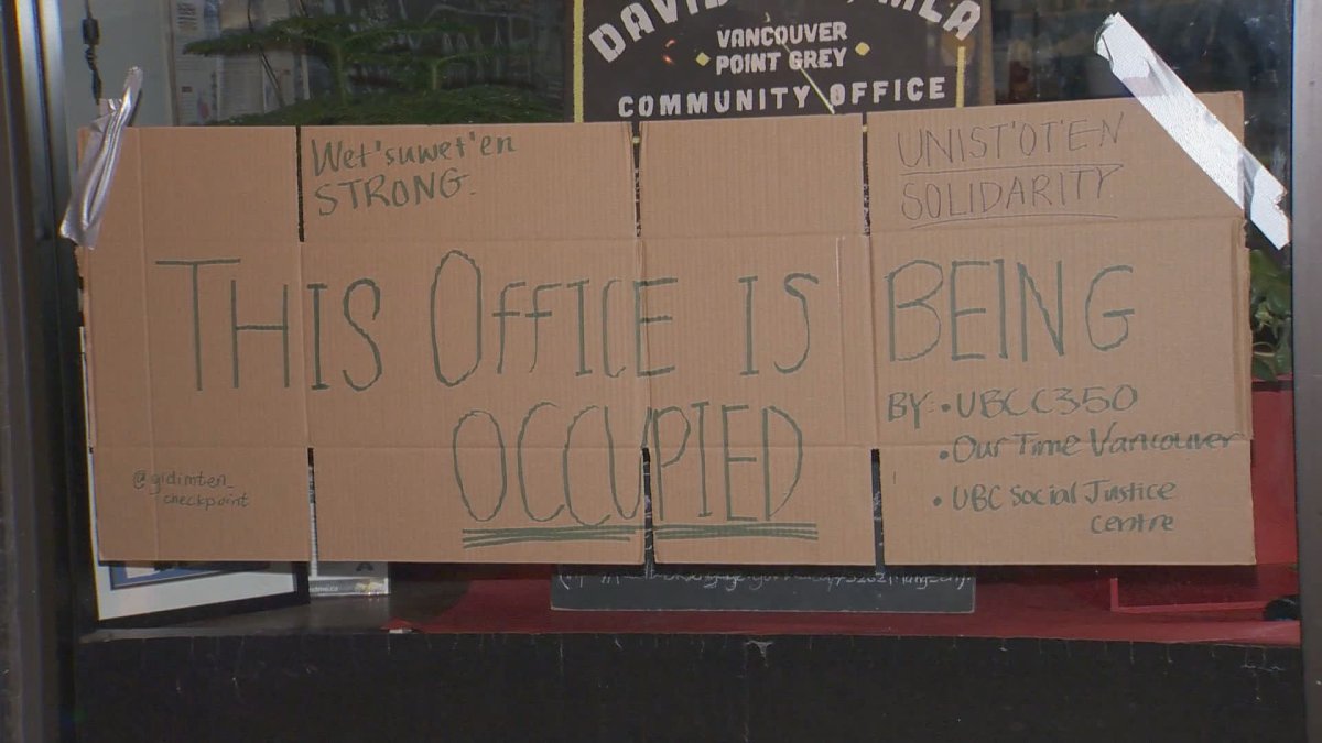 A sign left on the window of Attorney General David Eby's office after protesters occupied the space on Tuesday. 