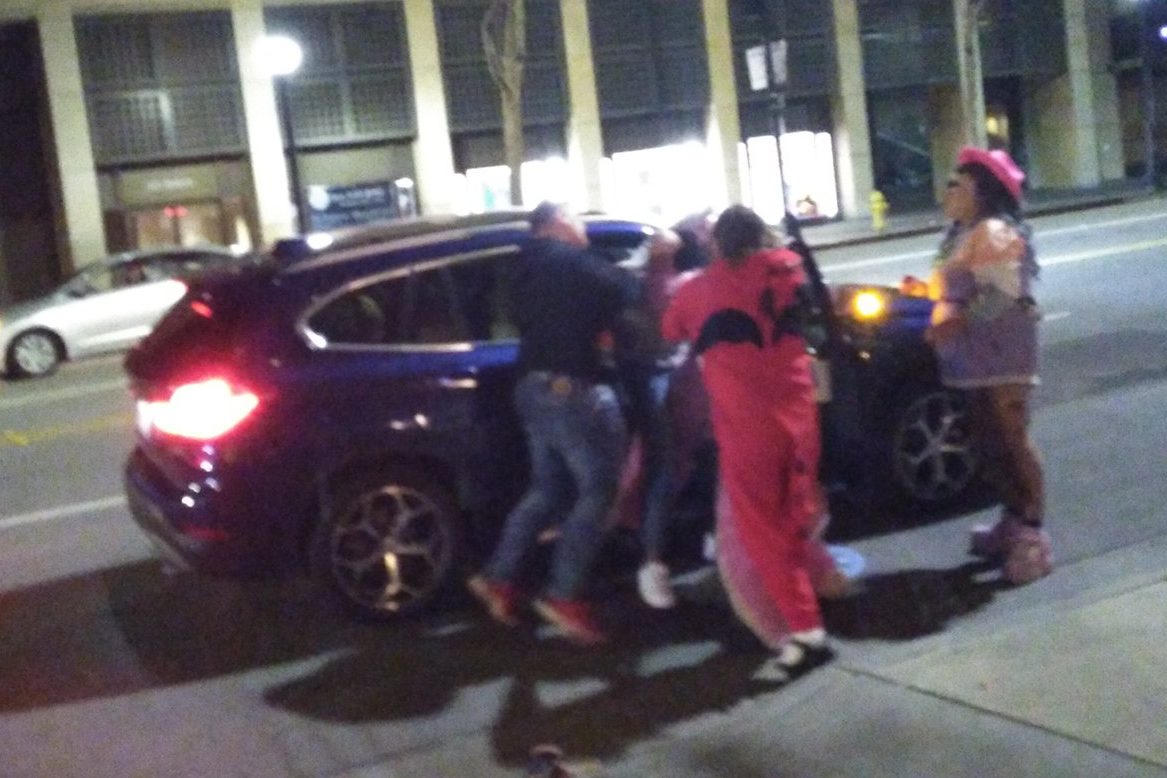 Several people wrestle a man out of a vehicle in San Jose, Calif., on Jan. 17, 2020.