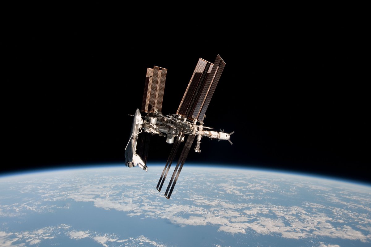 In this handout image provided by the European Space Agency (ESA) and NASA, the International Space Station and the docked space shuttle Endeavour orbit Earth during Endeavour's final sortie on May 23, 2011 in space.  