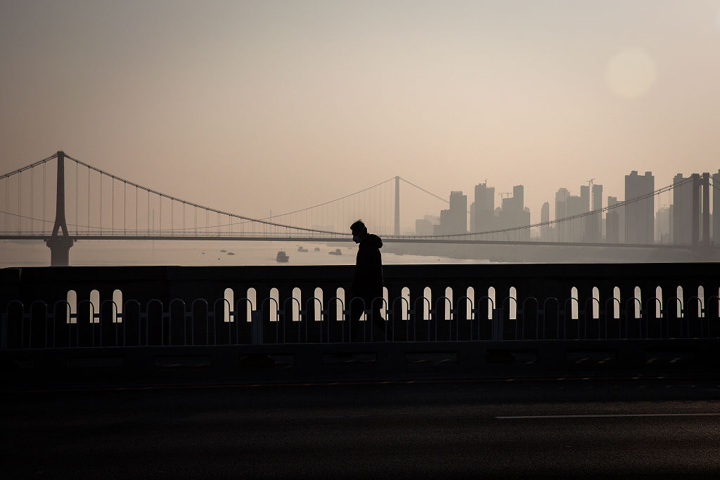 A resident wears a protective mask as he walks across the Yangtze River Bridge on Jan. 31, 2020 in Wuhan, China.
