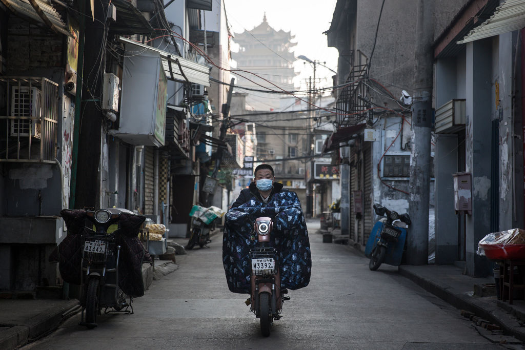 A resident wears a protective mask as he rides a motorbike in the street on Jan. 31, 2020 in Wuhan, China.