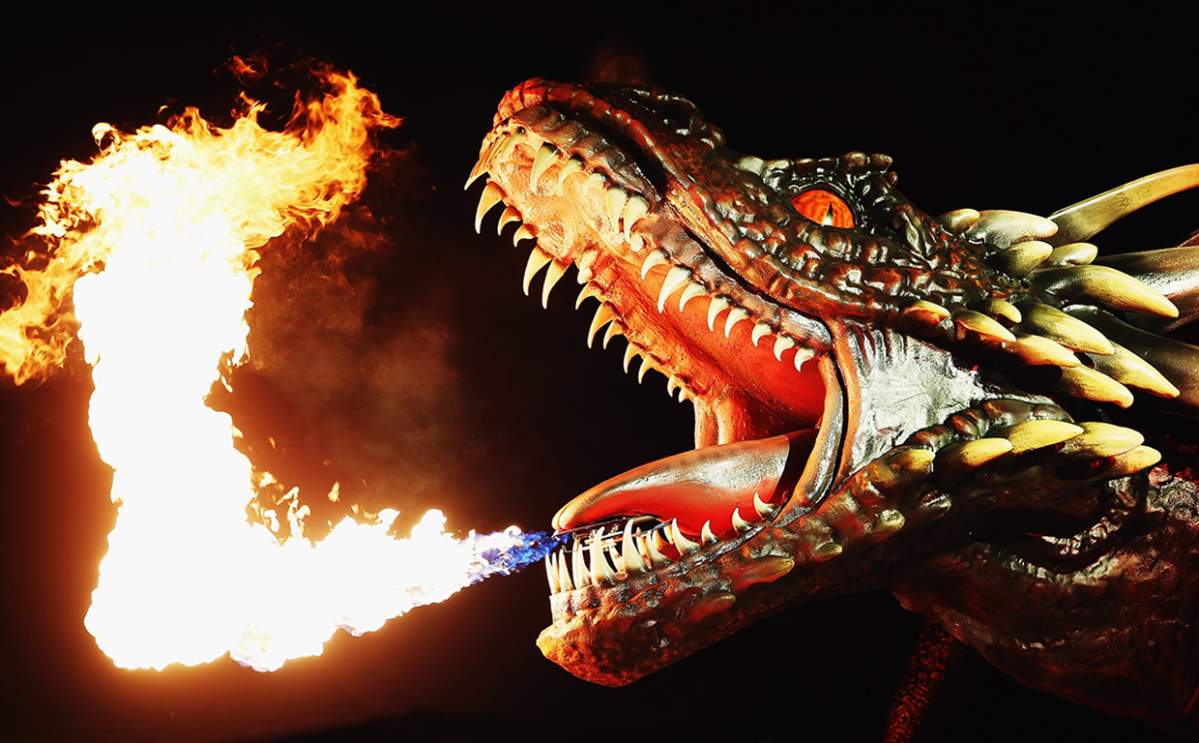 A dragon statue emits fire as people look on during the Sydney premiere of 'Game Of Thrones' at Sydney Opera House on April 13, 2015 in Sydney, Australia.
