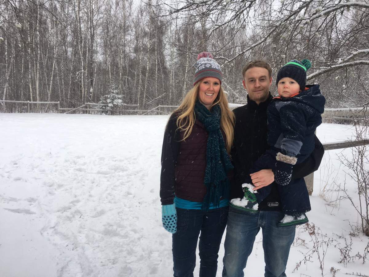 Gina Brown, her partner Jared Murphy and their son standing in front of the land where they hope to build a micro cannabis production facility.