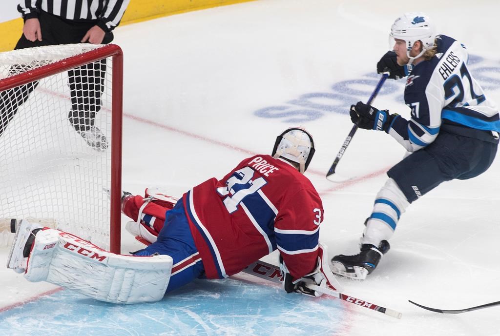 Winnipeg Jets’ Nikolaj Ehlers scores against Montreal Canadiens goaltender Carey Price during second period NHL hockey action against the Montreal Canadiens in Montreal on Jan. 6, 2020. THE CANADIAN PRESS/Graham Hughes