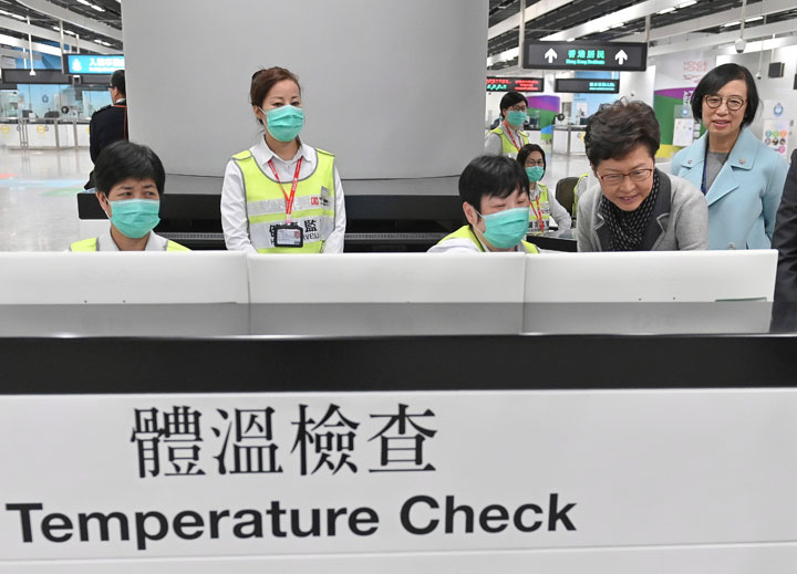 Officials review a health surveillance station at Hong Kong Airport, in this government handout photo.