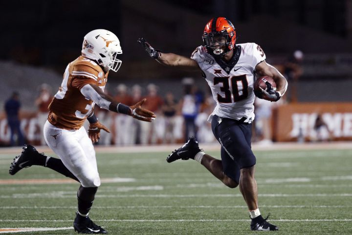 In this Sept. 21, 2019, file photo, Oklahoma State running back Chuba Hubbard (30) runs against Texas defensive back Montrell Estell (39) during the second half of an NCAA college football game, in Austin, Texas.