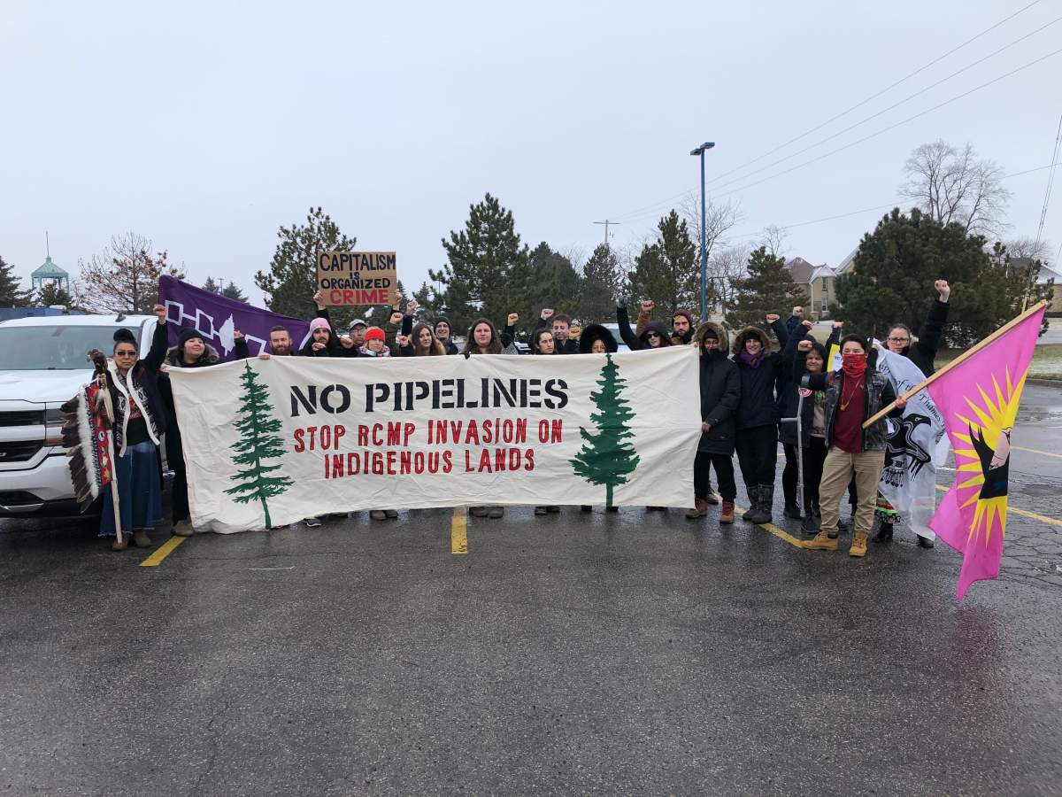 Protesters gather on Colonel Talbot Road south of Highway 401, where an Indigenous-led rolling blockade is getting ready to travel to Six Nations of the Grand River.