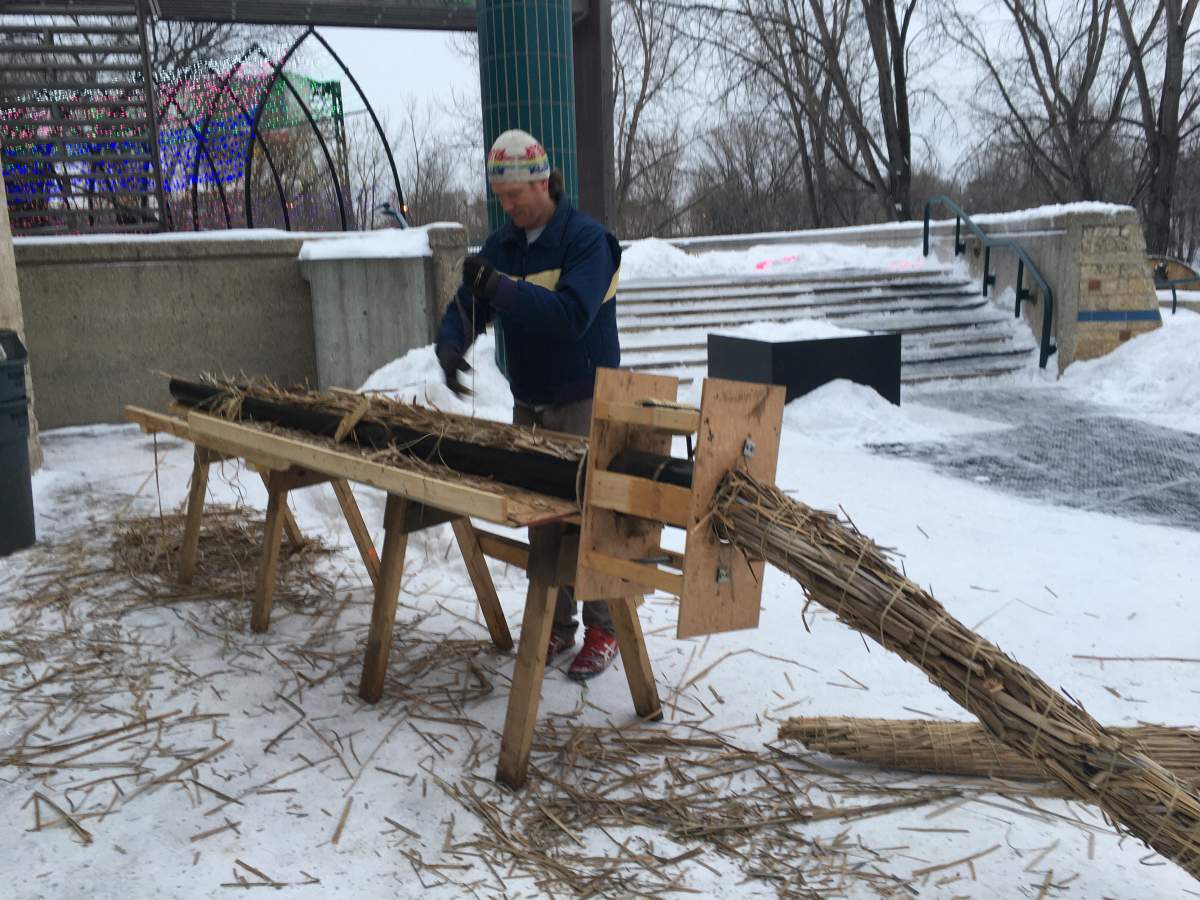 Construction crew member Stepfan Quiring using the Cattail baler.