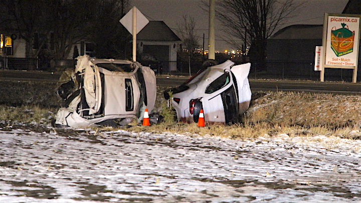 Two vehicles are seen in a field off of Ninth Line.