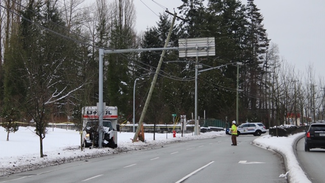 A U-Haul sits crashed into a sign post near a hydro pole it took down in Surrey on Jan. 18, 2020.